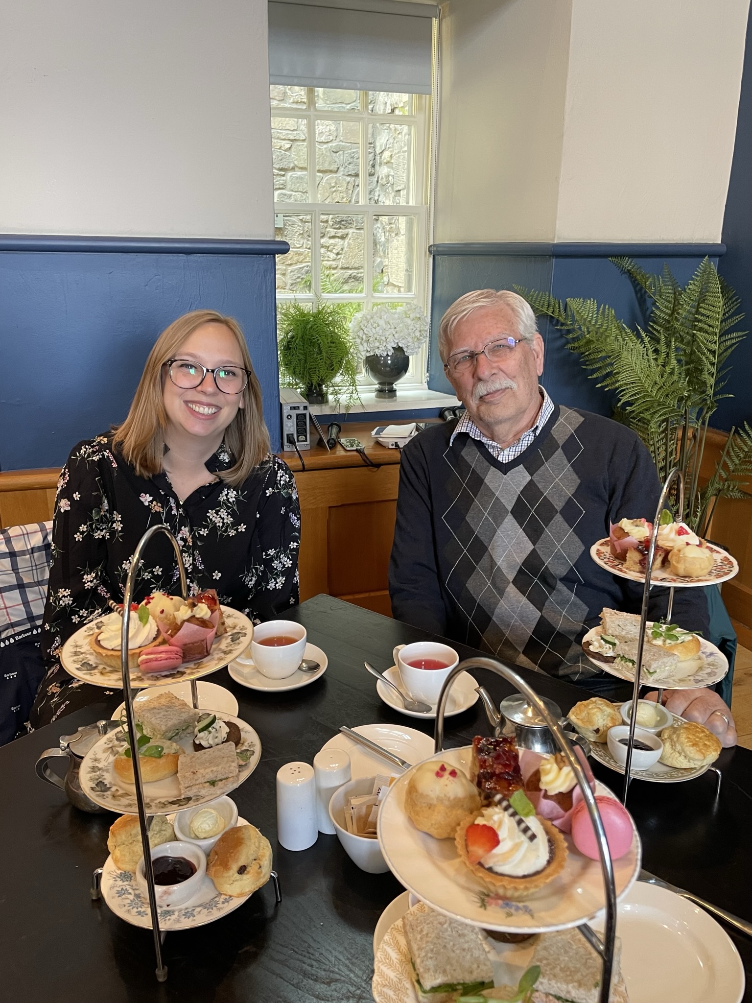 Lady and father enjoying afternoon tea